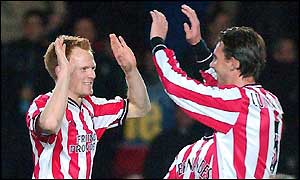 Michael Svensson celebrates with defensive partner Claus Lundekvam