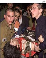 Wounded woman is taken to an ambulance