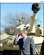 US President George W Bush salutes in front of a tank