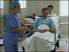 Photograph of an NHS patient on a hospital trolley