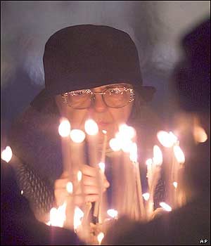 A woman lights a candle in St. Sava temple in the Serbian capital, Belgrade.