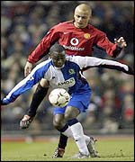 Blackburn's Andy Cole tussles with Man Utd's Wes Brown