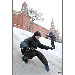 Russian boys slide down a snow hill near the Kremlin wall 