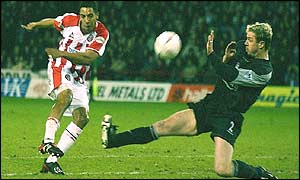 Sheffield United's Carl Asaba fires a chance over under challenge from Liverpool's Stephane Henchoz