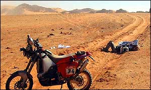 French Simon Droux lies down next to his KTM after falling and injuring his leg