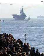 Crowds from the shore watch the HMS Ark Royal 