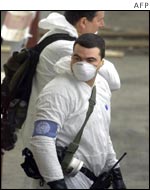 UN arms experts, wearing chemical suits, inspect a state company for marketing of medicines and medical equipment in Baghdad , Iraq
