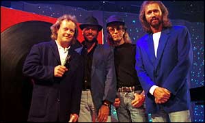 Bruno Brookes with the Bee Gees, Maurice, Robin and Barry Gibb after performing the song How Do I Fall In Love Part 1 on Top of the Pops in 1994