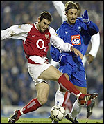 Birmingham new boy Christophe Dugarry challenges Arsenal's Martin Keown.