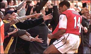 March 2001 - Thierry Henry celebrates with the Arsenal fans after scoring in the North London derby