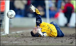 Chelsea goalkeeper Carlo Cudicini dives to try to stop Charlton scoring