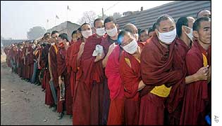 Buddhist monks queue to enter the Kalachakra festival in the town of Bodh Gaya