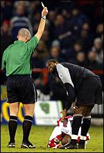 Salif Diao is booked for a foul on Peter Ndlovu