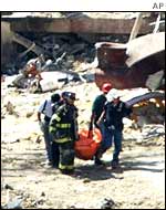 Rescuers remove a body from Ground Zero