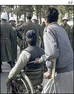 Police stand in front of disabled war veterans 