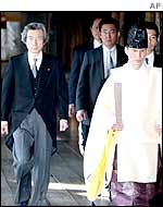 Japanese Prime Minister Junichiro Koizumi (left) follows a Shinto priest as the prime minister visits Yasukuni shrine, 14 Jan 2003