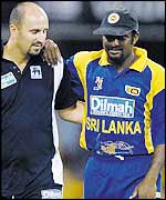 Muttiah Muralitharan is helped from the field by the Sri Lankan physio