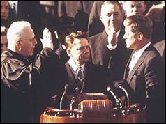 John F Kennedy (r) taking the oath of allegiance