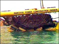 Mary Rose hull cushioned on its cradle inside the yellow lifting frame
