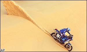 Richard Sainct of France negotiates the Egyptian dessert on his KTM