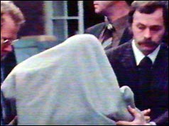 Gunman Barry Williams under a grey blanket, in custody