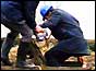 Policeman climbing into the drain shaft where Lesley Whittle's body was found