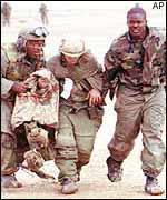 US Marines help an injured colleague in 1991