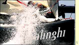 Alinghi's bowman Dean Phipps is splashed by a wave during the Swiss boat's victory in race five
