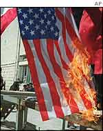 Palestinians burn a US flag