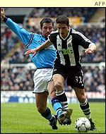 Newcastle winger Laurent Robert takes on Man City defender Richard Dunn