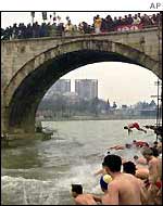 Orthodox Christians in Macedonia jump into the Vardar River