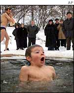 A boy dips in the icy waters of the Moscow River 
