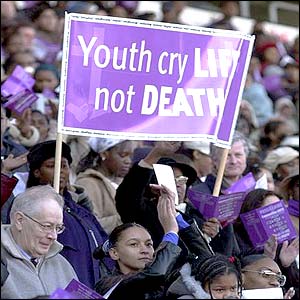 Poster in crowd at memorial concert