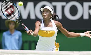 Venus Williams reaches for a shot against Justine Henin-Hardenne