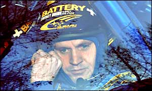 Finland's Tommi Makinen removes his helmet after retiring on the fifth stage of the first day of the rally