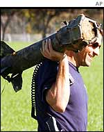 Israeli policeman takes away remains of Palestinian rocket in Sderot