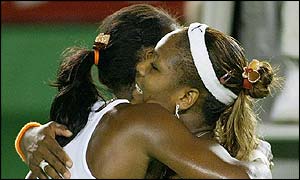 The Williams sisters embrace as Serena completes victory