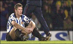 Dagenham and Redbridge captain Lee Matthews sits on the ground after defeat at Norwich