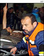 Emergency worker accompanies an injured man