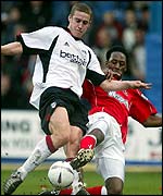 Fulham's Sean Davis is tackled by Jason Euell