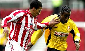 Stoke's Karl Henry challenges Danny Thomas of Bournemouth