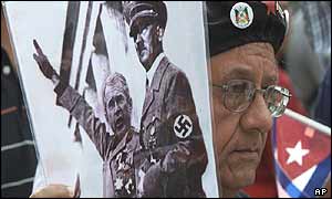 Demonstrator at the World Social Forum holds composite picture of Bush and Hitler 
