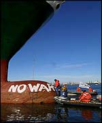 Greenpeace protesters paint slogans onto the Royal Navy supply ship