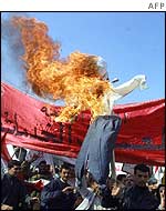 Iraqi protesters burn an effigy of President Bush in Baghdad