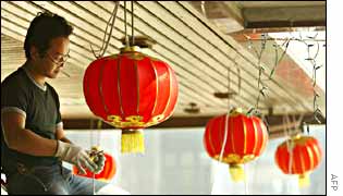 A worker in Hong Kong wires up lanterns in preparation for the celebrations