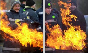 Striking firefighters warms their hands over a brazier, outside the Maryhill fire station in Glasgow 