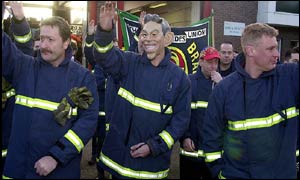 Striking firefighters, one sporting a Tony Blair mask, picket Watford Fire Station, Hertfordshire