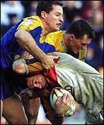 Michael Withers is tackled by Matt Adamson and Ben Walker