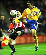 Paul Telfer (right) beats Julio Arca to the ball
