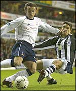 Simon Davies (left) evades Laurent Robert